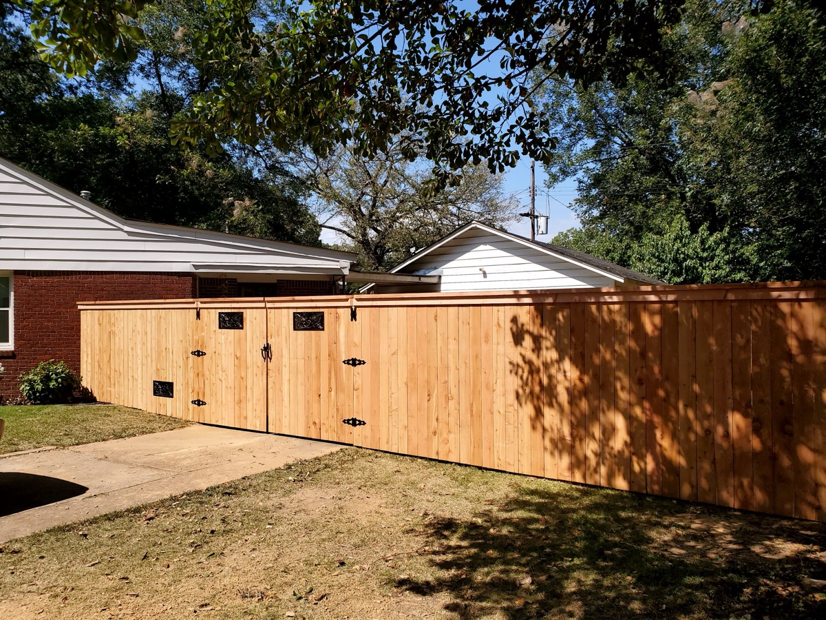 Double gate front view with decorative hardware in backyard