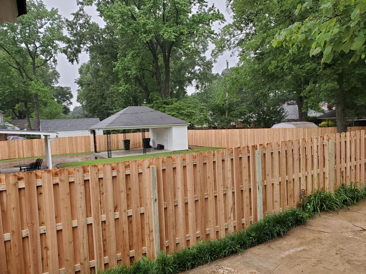 Board-on-board cedar fence in neighborhood with mature trees