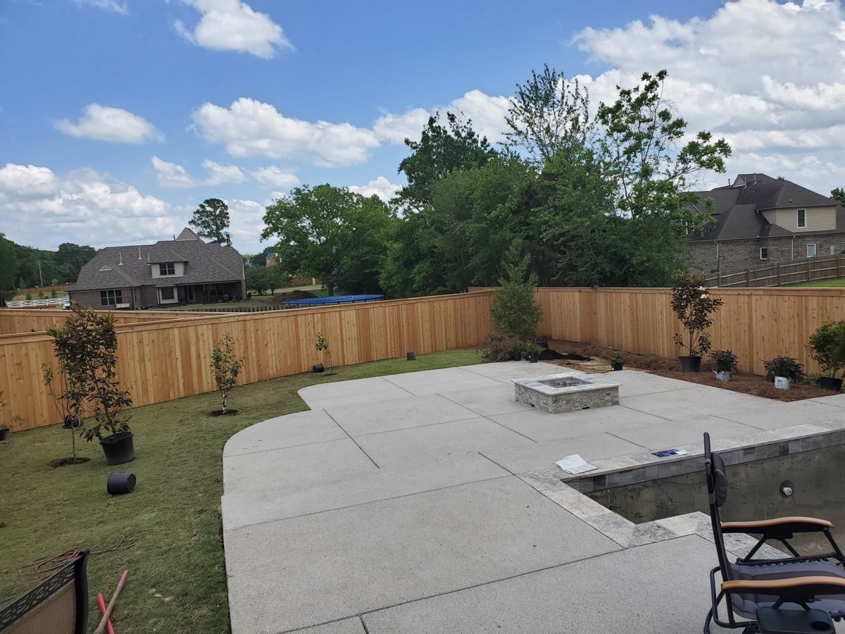 Cedar privacy fence around pool and patio area with fire pit