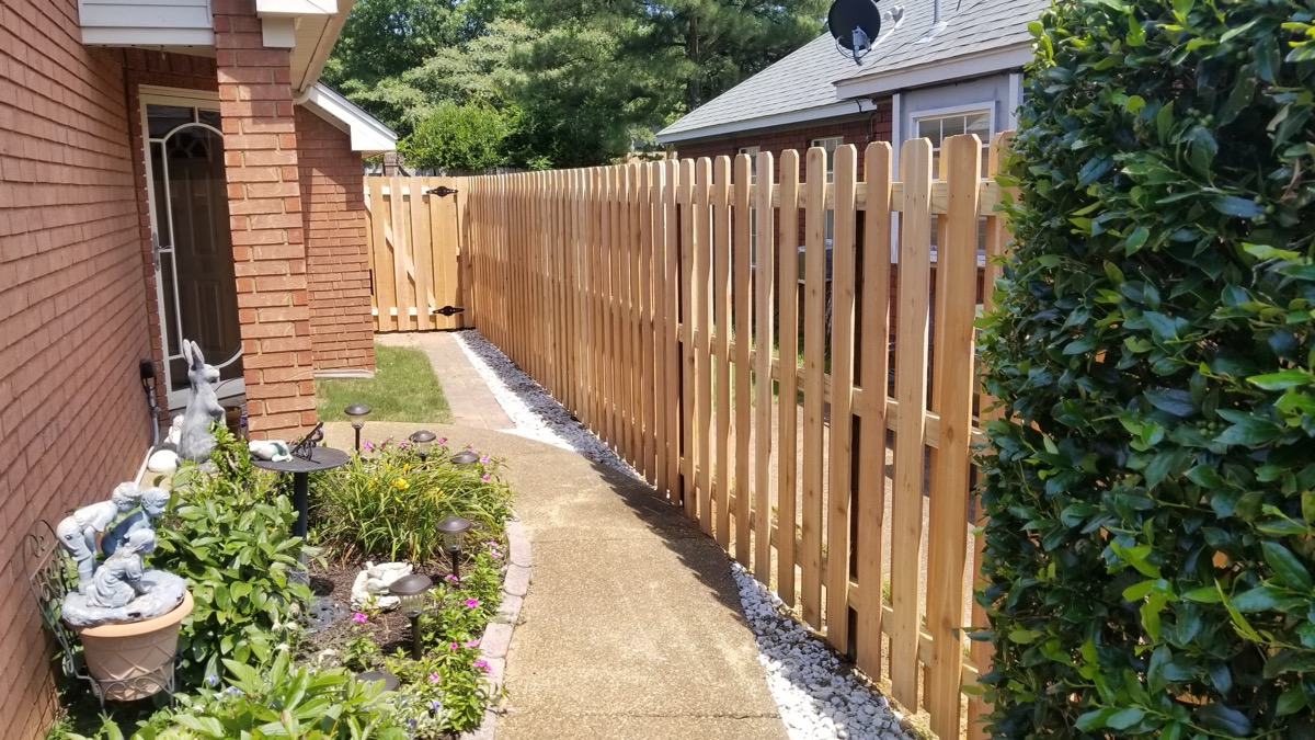 Shadowbox picket fence along side yard with garden path